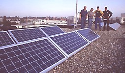 installation team "showing off" after delivery of 3 648 Wp PV-systems (one on sloping roof not shown)